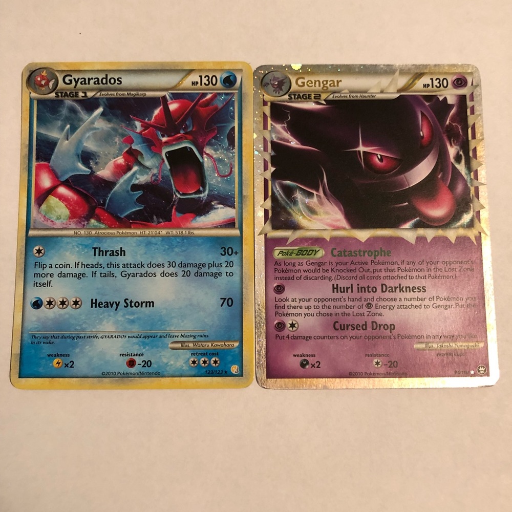 Pair of Pokémon cards 1 Gengar and 1 Gyarados with cases. No damage anywhere